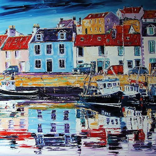 Fishing village with harbour, boats and rows of colourful houses.
